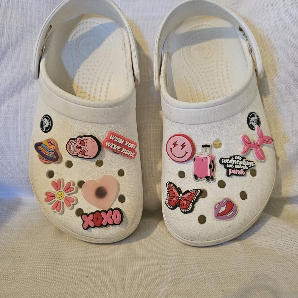 White Crocs With Assorted Pink Jibets. Womans Size 6. Used Condition.